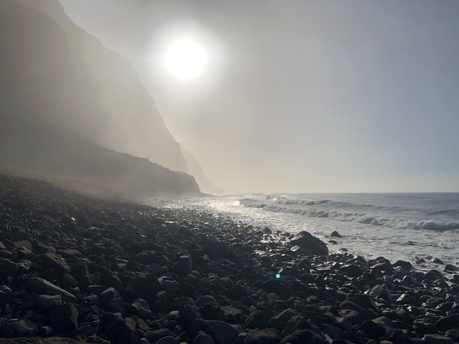 Mist over the far north-west shore, the sun behind the cliffs