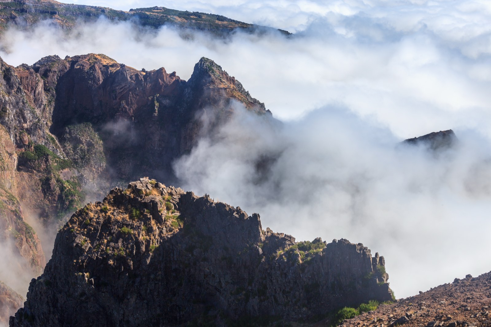 Rock ridges of the central peaks rising out of cloud near Pico do Arieiro