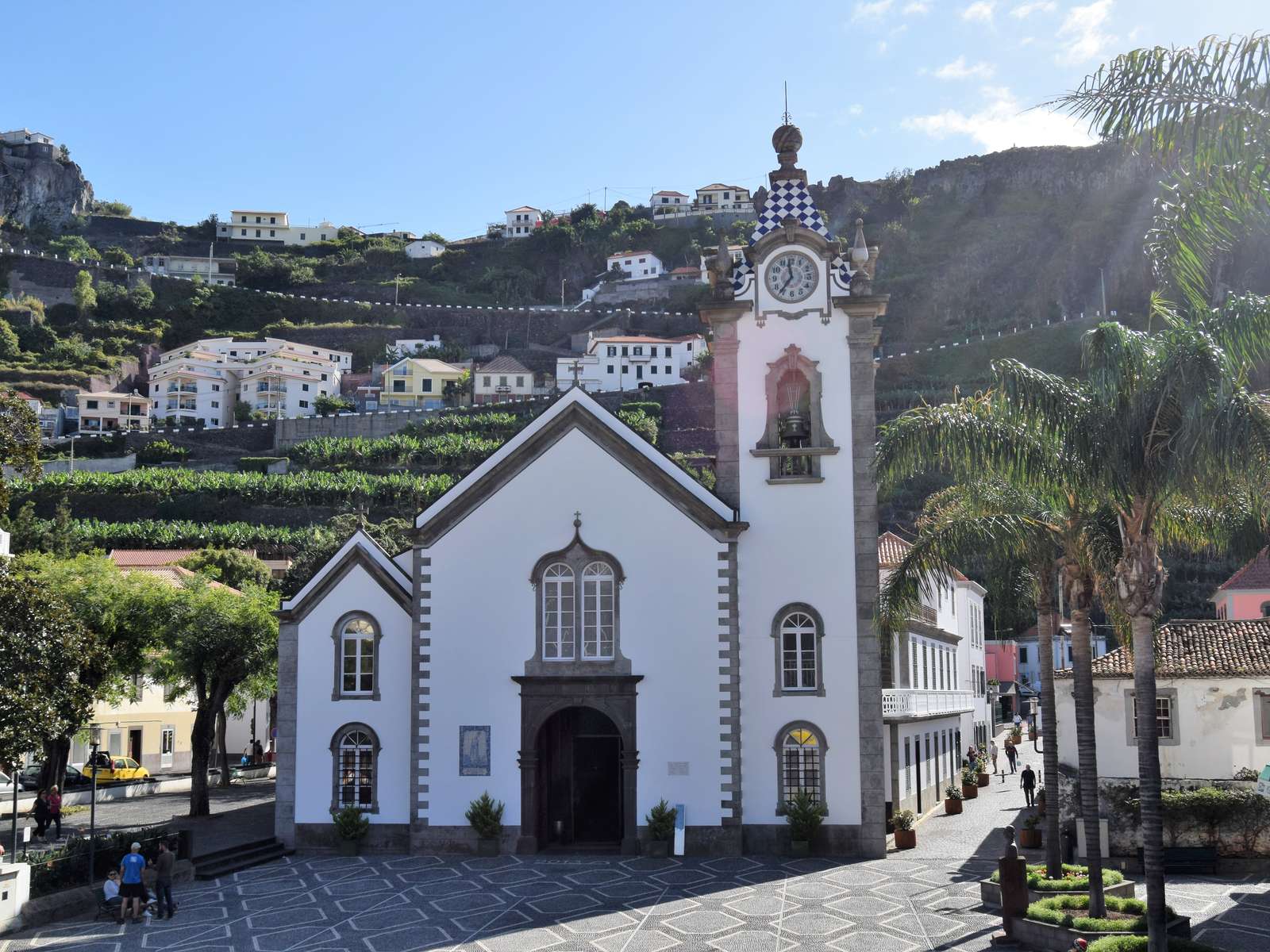 The white São Bento church in Ribeira Brava, its clock tower topped by a blue-and-white chequered spire