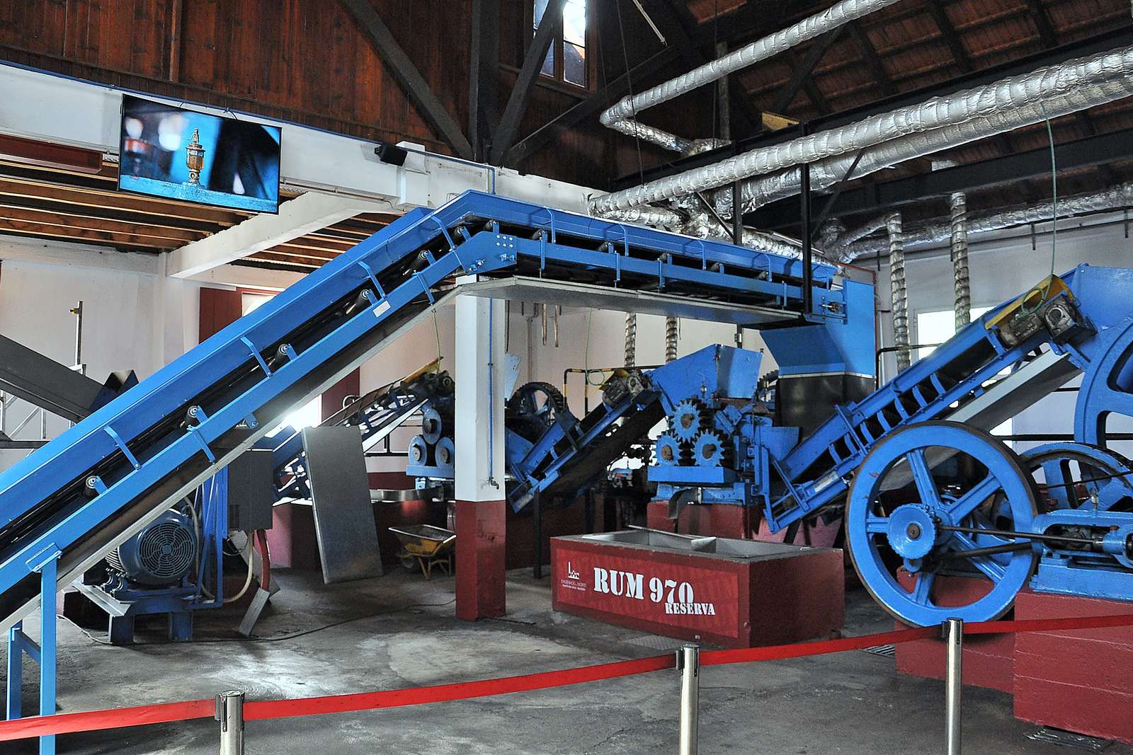 The blue cane-crushing mill inside the Engenhos do Norte distillery in Porto da Cruz