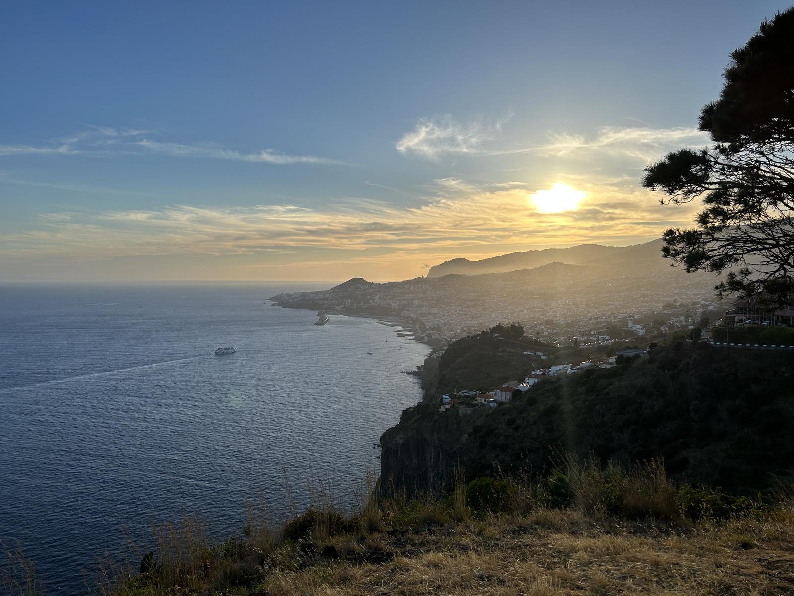 The sun going down over the hills behind Funchal bay, seen from the cliffs at São Gonçalo